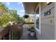 Cozy covered balcony with flower pots, overlooking a tree-lined street at 1470 S Quebec Way # 245, Denver, CO 80231
