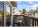 Cozy balcony features wood chair, outdoor decor and views of nearby homes and landscaping at 1470 S Quebec Way # 245, Denver, CO 80231