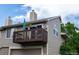 Exterior shot of a townhome with a brown balcony on the second story and an attached garage below at 1470 S Quebec Way # 245, Denver, CO 80231