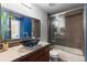 Modern bathroom featuring a vessel sink, updated fixtures and a shower with tile surround at 1470 S Quebec Way # 245, Denver, CO 80231