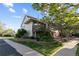 Charming home with landscaped yard, front deck and vibrant garden near a sidewalk at 1470 S Quebec Way # 245, Denver, CO 80231
