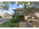 Charming condo entrance with a wooden porch, garden, and inviting steps leading to the front door at 1470 S Quebec Way # 245, Denver, CO 80231