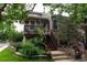 Inviting front entrance with a wooden porch and steps leading to a cozy brick home at 1470 S Quebec Way # 245, Denver, CO 80231