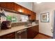 Contemporary kitchen featuring stainless steel appliances, mosaic backsplash, and view to living area at 1470 S Quebec Way # 245, Denver, CO 80231