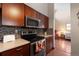 Stylish kitchen with stainless steel appliances, updated countertops, and sleek wooden cabinets at 1470 S Quebec Way # 245, Denver, CO 80231