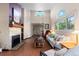 Inviting living room with a stone fireplace, vaulted ceilings, large windows, and hardwood floors at 1470 S Quebec Way # 245, Denver, CO 80231
