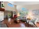 Bright living room featuring high ceilings, large windows, hardwood floors, and comfortable seating at 1470 S Quebec Way # 245, Denver, CO 80231