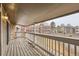 Relaxing balcony with wooden floors, a sturdy white railing, and views of the surrounding community at 18091 E Kentucky Ave # 202, Aurora, CO 80017