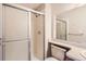 A clean and simple bathroom with a sliding glass door shower and neutral tones at 18091 E Kentucky Ave # 202, Aurora, CO 80017