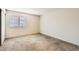 Neutral bedroom with carpeting, large windows, and a spacious closet at 18091 E Kentucky Ave # 202, Aurora, CO 80017