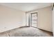 Bright, carpeted bedroom with sliding glass doors leading to a balcony at 18091 E Kentucky Ave # 202, Aurora, CO 80017