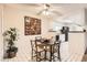Cozy dining room with a ceiling fan and an adjacent kitchen area with black appliances at 18091 E Kentucky Ave # 202, Aurora, CO 80017