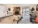 Inviting living room with a stone fireplace, sliding doors, and neutral carpeting at 18091 E Kentucky Ave # 202, Aurora, CO 80017