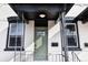 Charming home exterior showcases a light green front door, black trim, and house number over white brick at 1470 Knox Ct, Denver, CO 80204