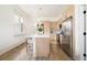 Contemporary kitchen featuring an island with bar seating, stainless steel appliances, and natural light at 1470 Knox Ct, Denver, CO 80204