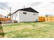 Spacious backyard with a wooden fence and well-maintained grass, perfect for outdoor activities and relaxation at 930 S Lowell Blvd, Denver, CO 80219