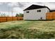 Expansive backyard with a large lawn, wooden fence, and mature trees at 930 S Lowell Blvd, Denver, CO 80219