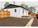 Backyard featuring new landscaping, a deck, and a wooden fence at 930 S Lowell Blvd, Denver, CO 80219