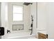 Modern bathroom with a shower-tub combo, niche, matte black fixtures, and custom vanity at 930 S Lowell Blvd, Denver, CO 80219