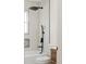 Modern bathroom featuring a shower-over-tub with matte black fixtures, white tile, and stylish accents at 930 S Lowell Blvd, Denver, CO 80219