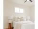 Bright bedroom with hardwood floors, white walls, two bedside tables, and lots of natural light at 930 S Lowell Blvd, Denver, CO 80219