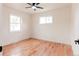 Bright, airy bedroom with hardwood flooring and two windows, offering natural light at 930 S Lowell Blvd, Denver, CO 80219