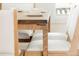 Close up of a modern dining table with white upholstered chairs and neutral decor at 930 S Lowell Blvd, Denver, CO 80219