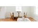 Dining room featuring hardwood floors, white walls, a wood table, and lots of natural light at 930 S Lowell Blvd, Denver, CO 80219