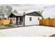 Exterior view of a house featuring a fenced yard, covered porch, and a tidy landscaped area at 930 S Lowell Blvd, Denver, CO 80219
