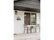 Inviting front porch with seating, views of the house number and exterior features of the home at 930 S Lowell Blvd, Denver, CO 80219