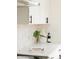 Stylish kitchen counter with white cabinets, black hardware, and elegant decor at 930 S Lowell Blvd, Denver, CO 80219