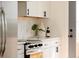 Kitchen counter with white cabinets, black hardware, and stylish decor at 930 S Lowell Blvd, Denver, CO 80219