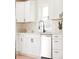 Bright, updated kitchen showcasing modern appliances, white cabinetry, and stylish backsplash at 930 S Lowell Blvd, Denver, CO 80219
