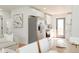 Bright, open kitchen featuring white cabinets, stainless steel appliances, and hardwood floors at 930 S Lowell Blvd, Denver, CO 80219