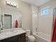 Bright bathroom with a shower-tub combo, a wide mirror, and modern fixtures at 11999 S Stroll Ln, Parker, CO 80138