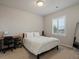 Bright bedroom featuring a modern desk, plush bedding, and natural light from a window at 11999 S Stroll Ln, Parker, CO 80138