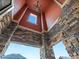 Inviting front porch featuring stone columns, wood ceiling, and an elegant chandelier at 11999 S Stroll Ln, Parker, CO 80138