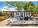 Back deck features seating area, fire pit, and view of fenced yard with enclosed porch at 6598 S Logan St, Centennial, CO 80121