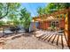 Backyard includes a gravel patio, hammock, trees, and outdoor living space at 6598 S Logan St, Centennial, CO 80121