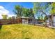 Well-maintained yard with fence, gardening boxes, and an enclosed patio offers privacy and space at 6598 S Logan St, Centennial, CO 80121