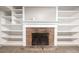Basement fireplace with built-in shelving for storage and display at 6598 S Logan St, Centennial, CO 80121
