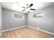 Bedroom boasts hardwood floors, ceiling fan, and abundant natural light from large windows at 6598 S Logan St, Centennial, CO 80121