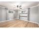 Bright bedroom featuring refinished hardwood floors, neutral paint, and updated lighting fixtures at 6598 S Logan St, Centennial, CO 80121