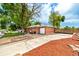 Lovely brick home featuring an extended driveway, lush trees, and a fenced backyard at 6598 S Logan St, Centennial, CO 80121