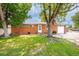 Charming brick home with mature trees and a well-manicured lawn offering great curb appeal at 6598 S Logan St, Centennial, CO 80121