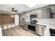 Updated kitchen with stainless steel appliances, subway tile backsplash, and a breakfast nook at 6598 S Logan St, Centennial, CO 80121