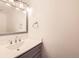 Bathroom vanity with white sink and countertop with modern mirror and lighting fixtures at 11155 W 17Th Ave # 103, Lakewood, CO 80215