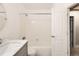 Bathroom featuring white tile, a tub-shower combo, and marble countertop vanity at 11155 W 17Th Ave # 103, Lakewood, CO 80215
