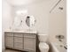 Bathroom with double sinks, white marble countertops, and a shower-tub combination at 11155 W 17Th Ave # 103, Lakewood, CO 80215
