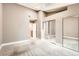 Bedroom with skylight, neutral walls, plush carpet, and a closet with mirrored doors at 11155 W 17Th Ave # 103, Lakewood, CO 80215
